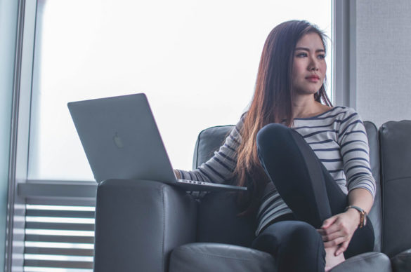 Seated woman with laptop dealing with job rejection